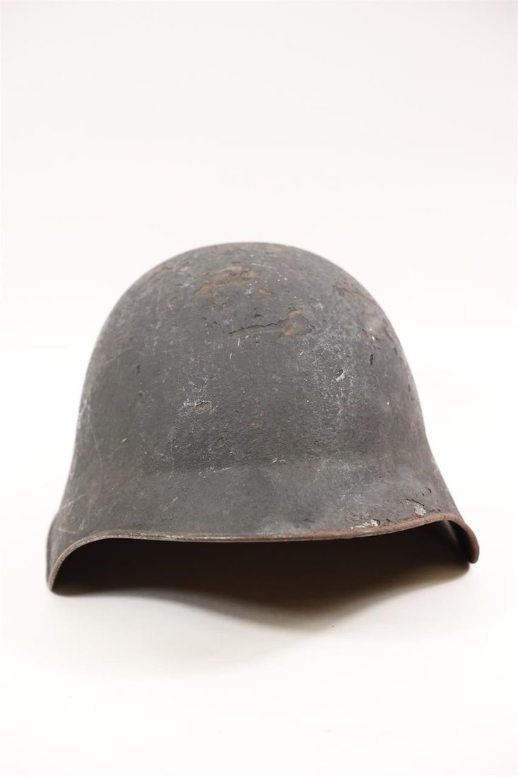 Swiss Army M18 Steel Combat Helmet: An original Swiss M1918 (M18) combat helmet. It was introduced into service by the Swiss military in 1924 and used until the M1971 replacement. The helmet's design was influenced by German WWI