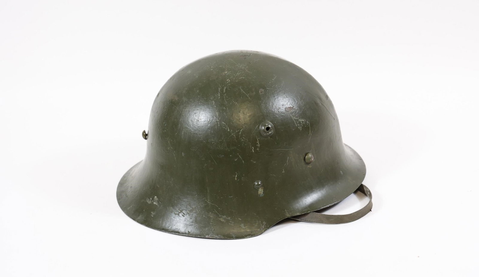 WWII Bulgarian M36 Steel Combat Helmet: Bulgarian Model 1936 (M36) steel combat helmet, primarily used during World War II. A military collectible representing Bulgaria's wartime equipment from the period.