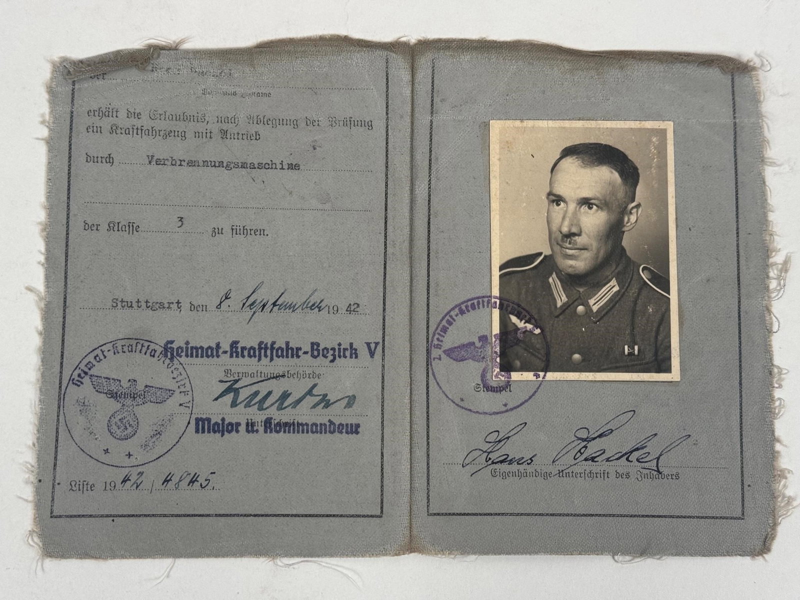 WWII German Wehrmacht Driver's License (1942): Original WWII-era German Wehrmacht driver's license issued in Stuttgart in 1942, complete with period photo, official stamps, and original signature. Issued by the Heimat-Kraftfahr-Bezirk authority.