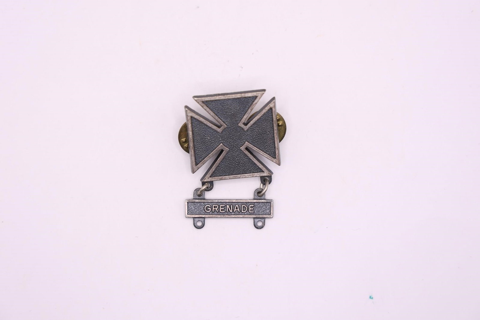 WWII US Army Marksman Grenade Qualification Bar: This is a US Army Marksman qualification badge with a "Grenade" qualification bar. The badge is awarded to military personnel who achieve a basic level of proficiency with a specific weapon. The