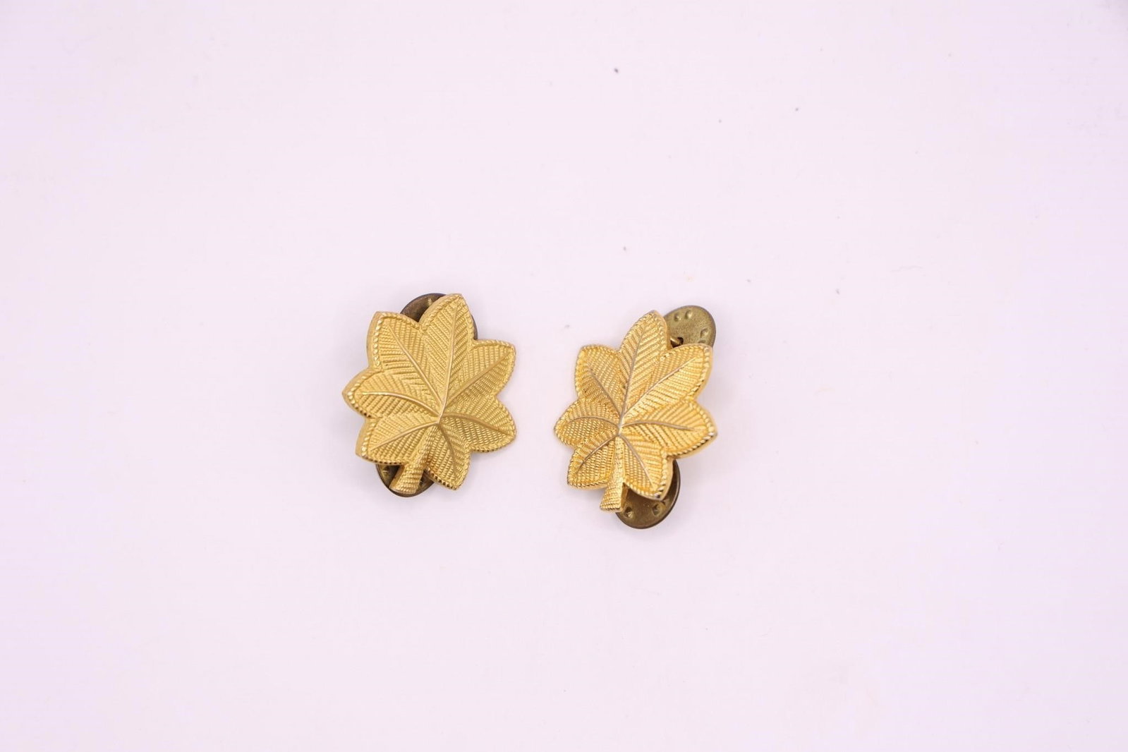 WWII US Army Major O4 Pay Grade Rank Insignia Pins: These are US Army Major (O-4 pay grade) rank insignia pins, featuring a gold-tone oak leaf design. Used to denote the rank of Major in the U.S. Army. The use of an oak leaf for the rank dates back to