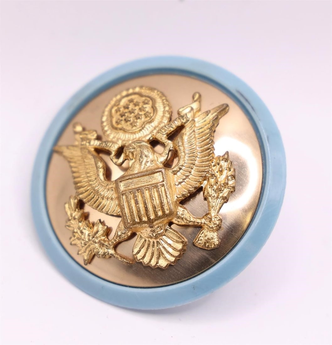 WWII US Army Officer's Cap Insignia: This is a US Army Officer's cap insignia, also known as a service cap device. It features the Coat of Arms of the United States, which is a common military cap badge design distinguishing the