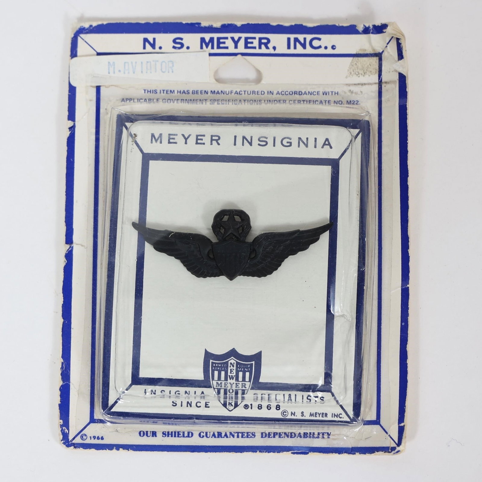 Vintage NS Meyer M-Aviator Insignia Pin: This is a vintage N.S. Meyer M-Aviator insignia pin, still on its original 1966 packaging. Manufacturer: N. S. Meyer, Inc., a well-known maker of military insignia and uniform accessories. Design: The