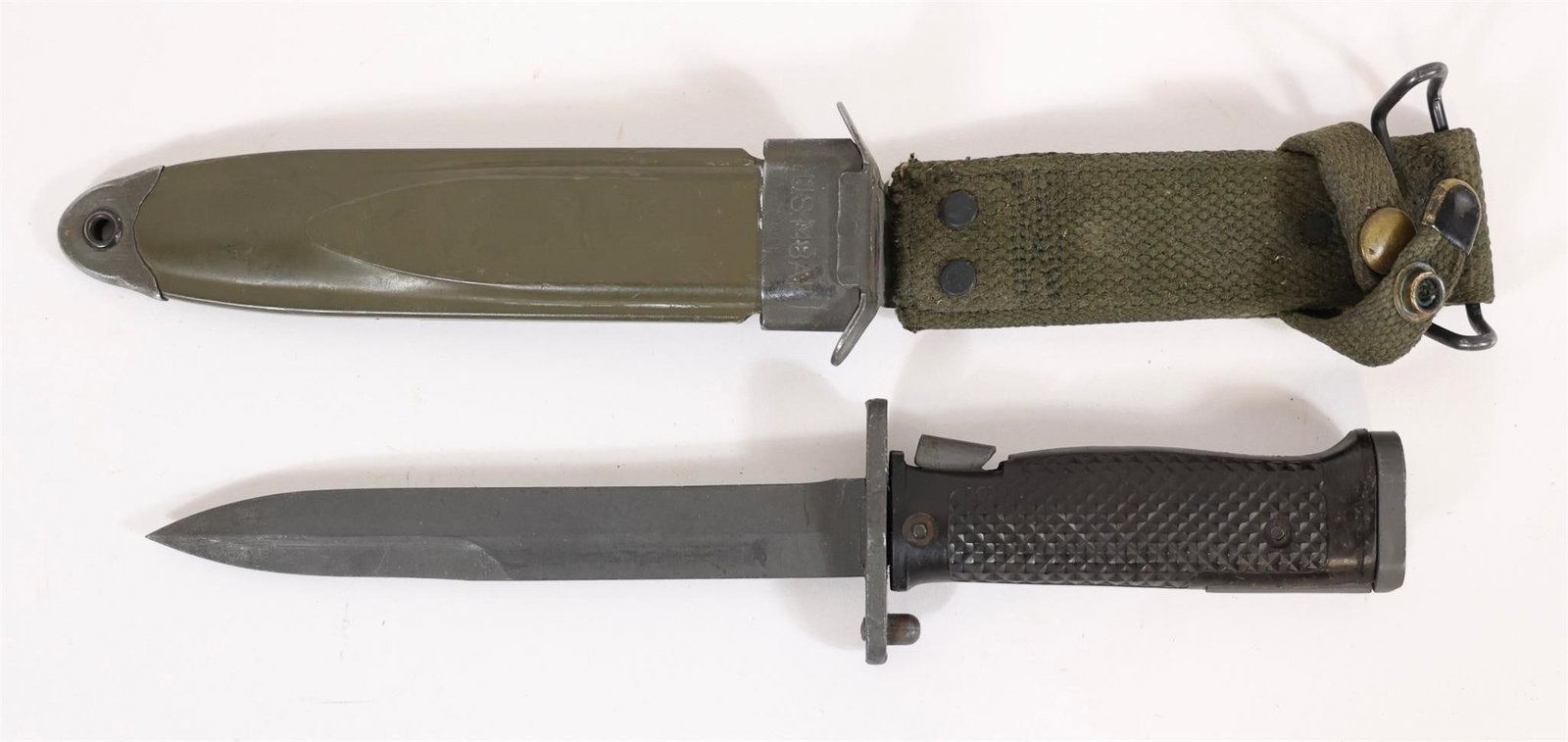 US M5 Bayonet and Scabbard: Military-style bayonet with straight blade, textured black grip, and integrated mounting mechanism. Includes olive drab scabbard with canvas hanger and metal fittings. Approximate measurements: 11" ov