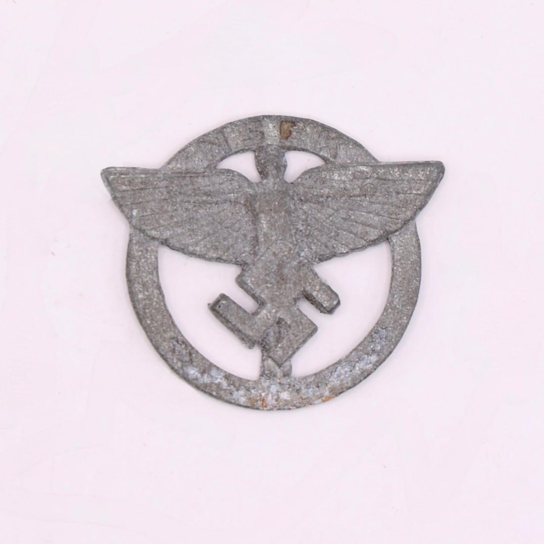NSFK Member's Badge: This is a metal badge from the National Socialist Flyers Corps (NSFK), a paramilitary aviation organization active in Germany at the time. It features the group's winged-figure emblem within a circula