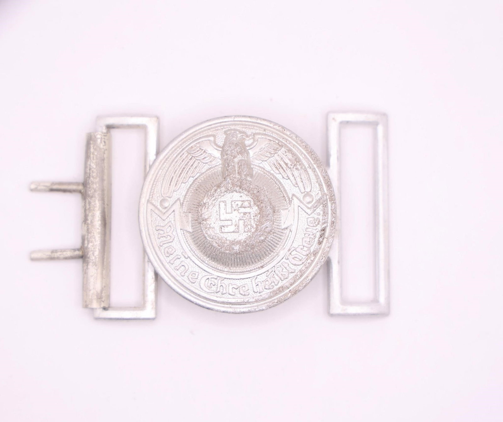 WWII German Military Belt Buckle: Original period German military belt buckle featuring historically significant insignia associated with World War II. Metal construction with age-related wear, patina, oxidation, and handling marks