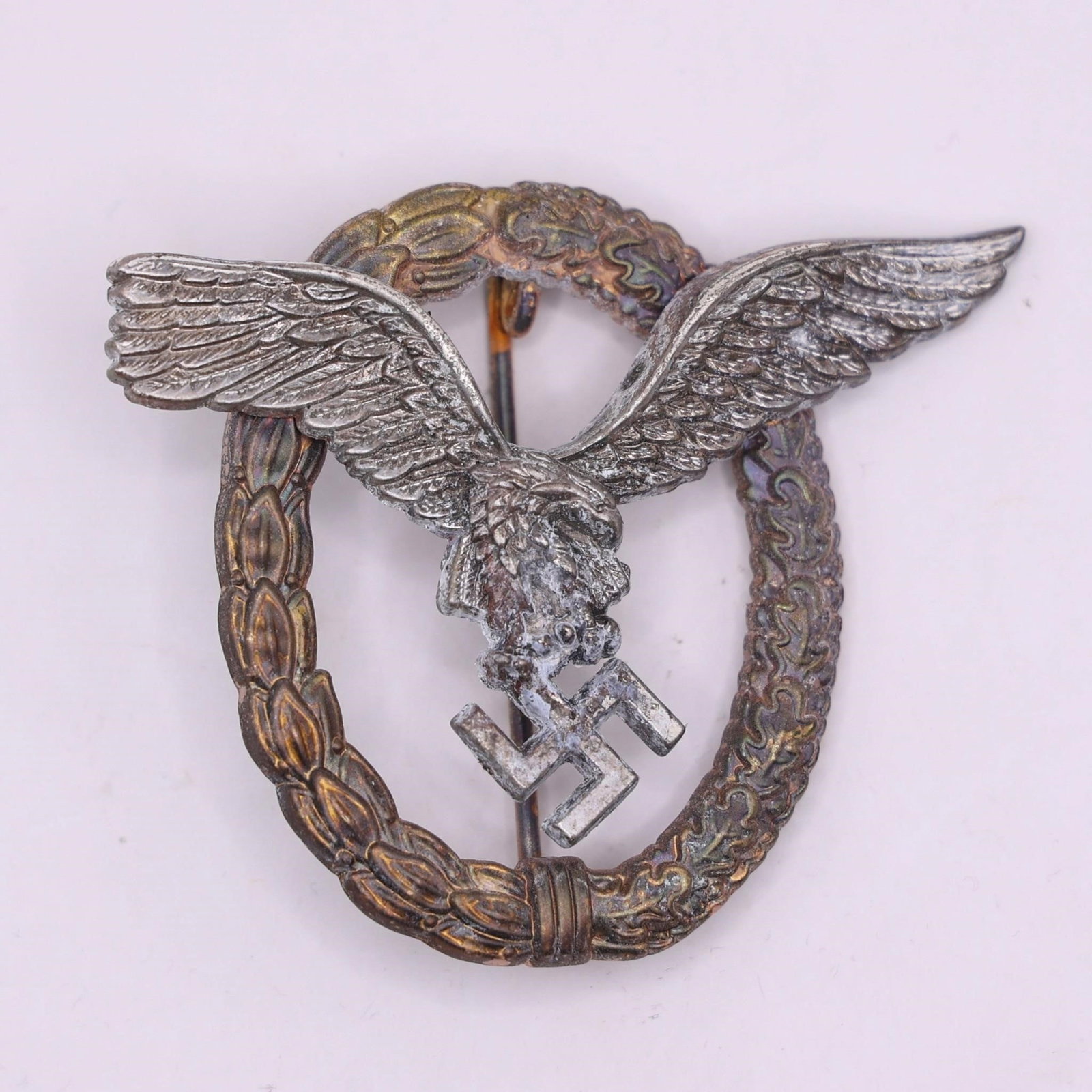 German WWII Luftwaffe Pilot Badge Eagle & Wreath: This German WWII Luftwaffe Pilot Badge features the classic eagle in flight over a laurel and oak leaf wreath.