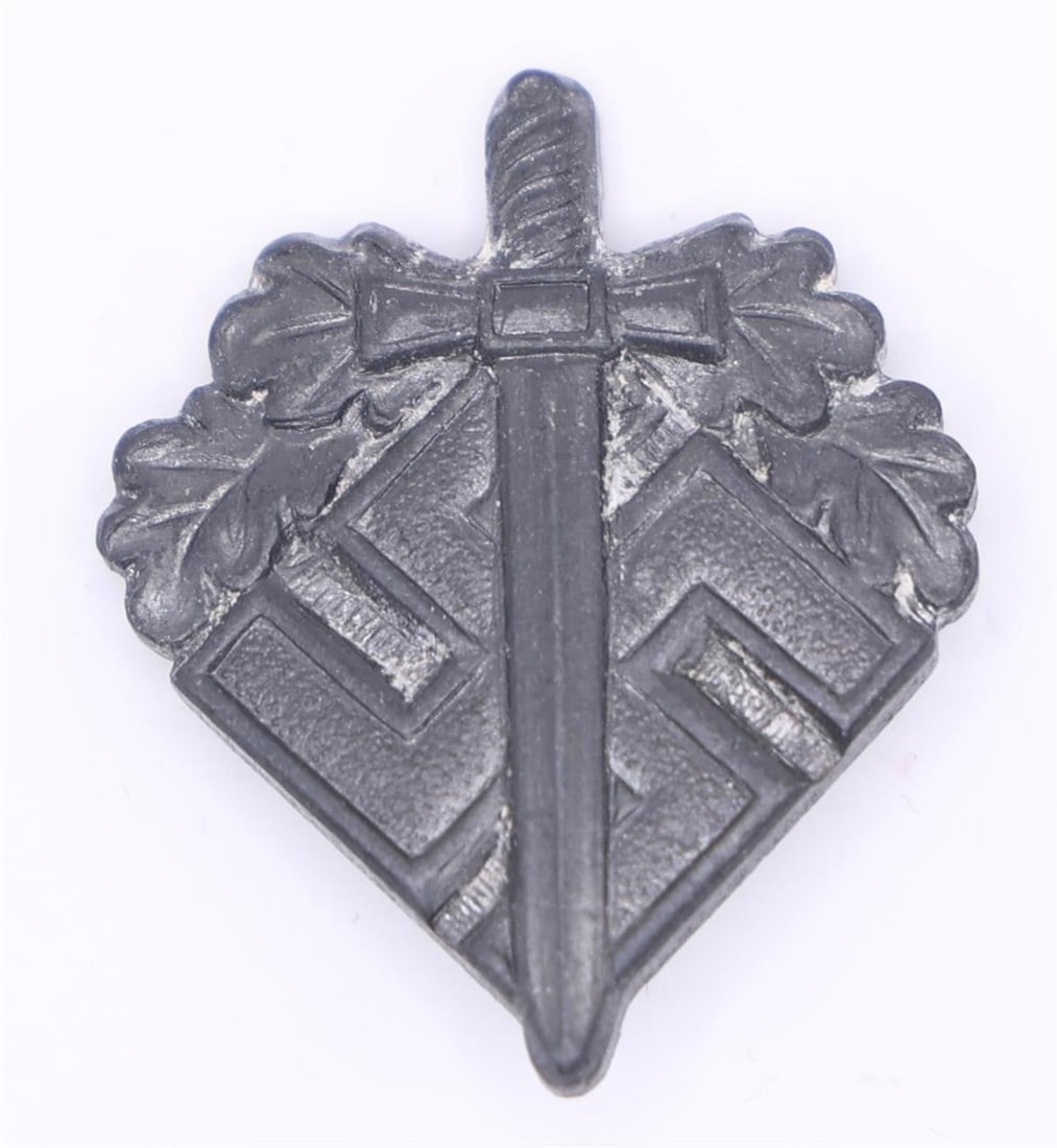 NSKOV Donation Pin (WWII Era): A small aluminum lapel pin issued by the NSKOV, an organization that supported wounded German veterans. The front shows a sword laid over a swastika with oak leaves around the upper portion. The