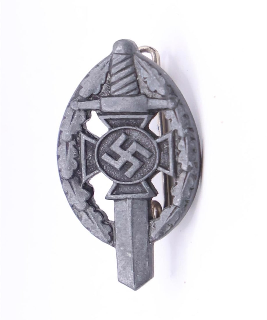 Germany III Reich NSKOV Badge: German Third Reich NSKOV (National Socialist War Victim's Care) badge, metal construction with pin back, typical period design, good condition.