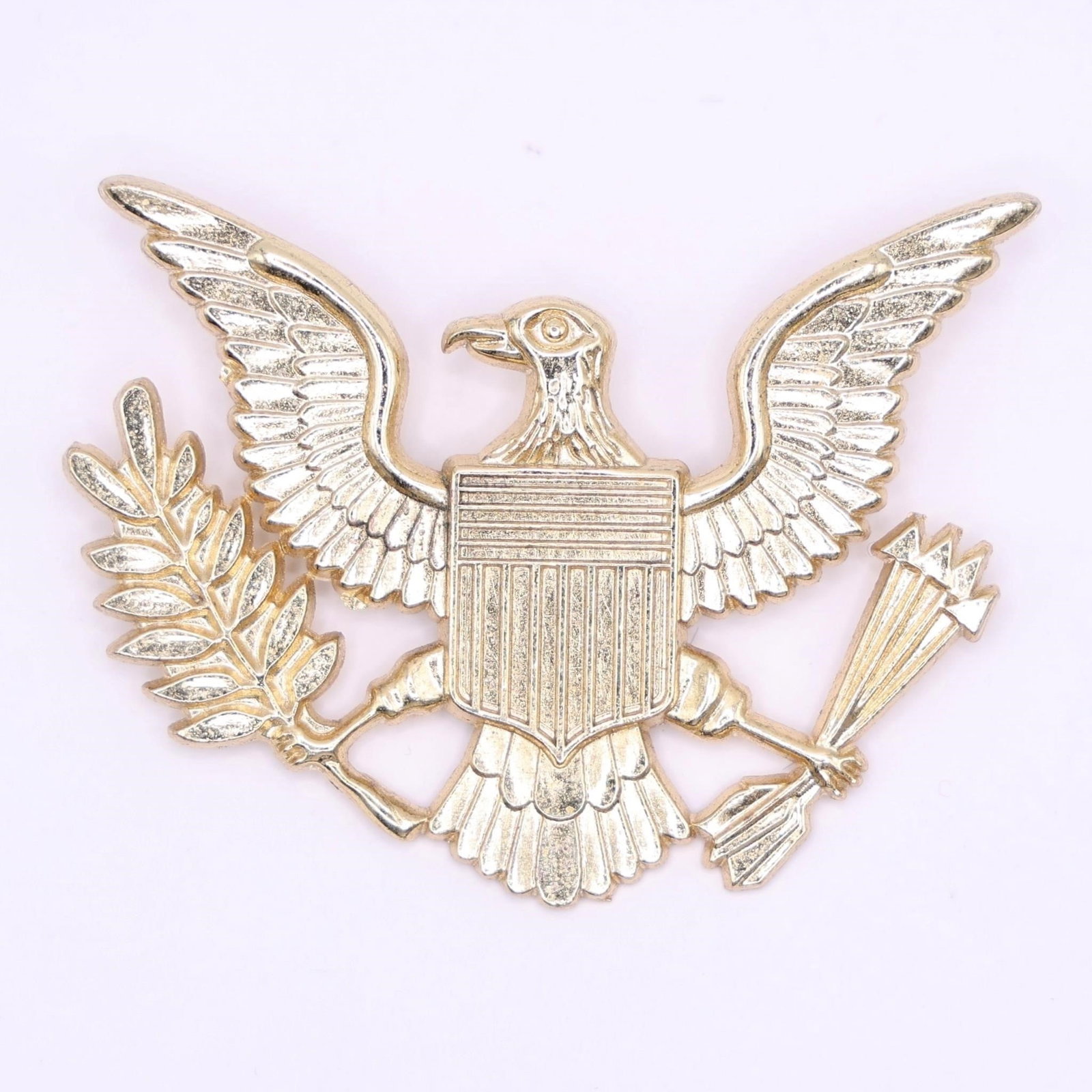 US Military Badge: U.S. military insignia, specifically an officer's cap or breast badge featuring the Coat of Arms of the United States.Dimensions: 2.5in x 2in