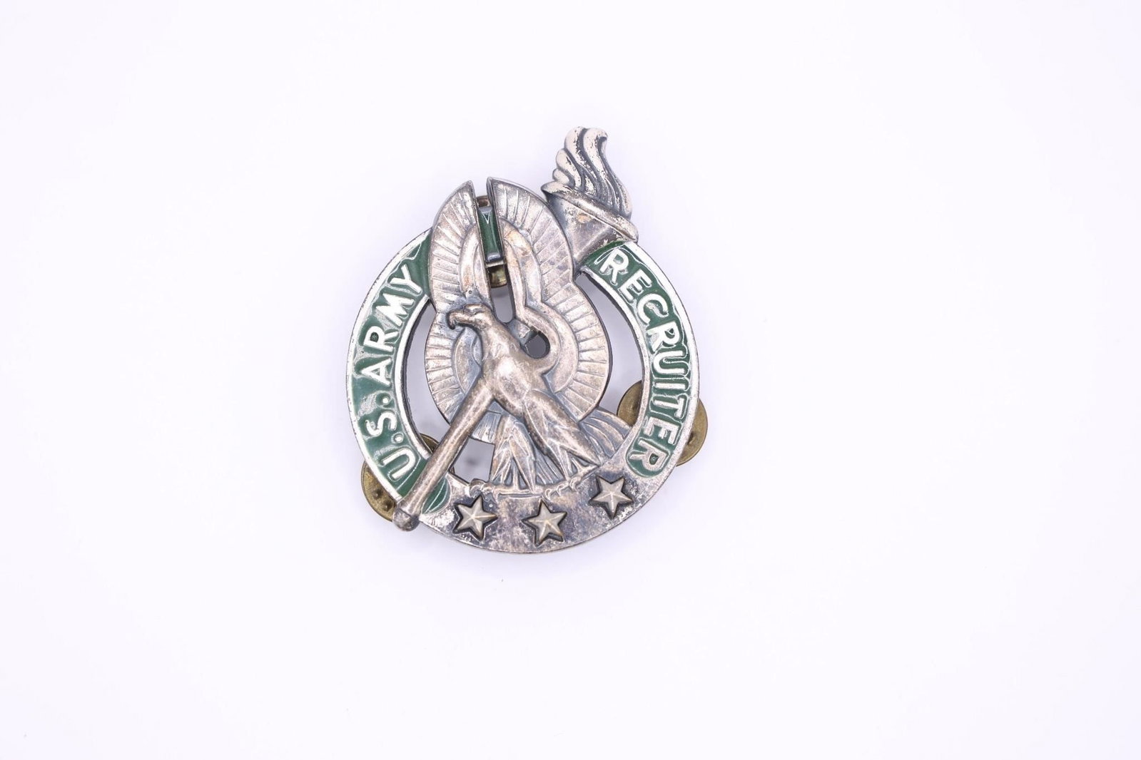 US Army Basic Recruiter Id Badge: U.S. Army Basic Recruiter Identification Badge. It is a silver crest presented to active and reserve Army personnel assigned to the U.S. Army Recruiting Command (USAREC). The badge features a