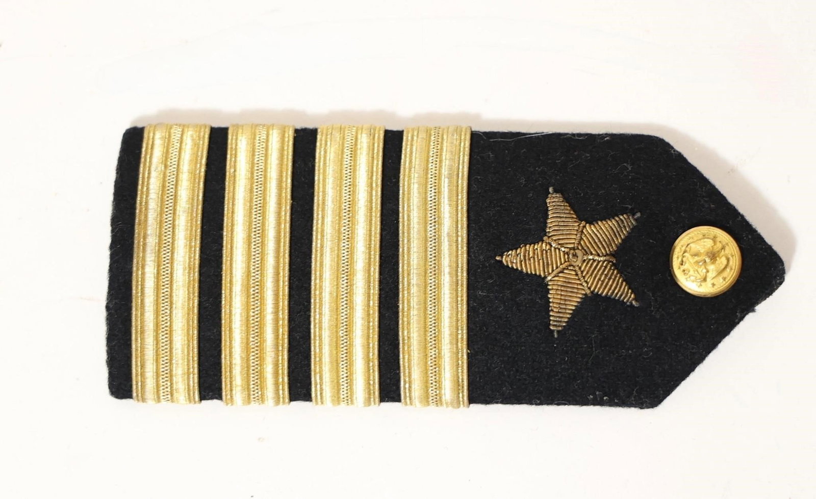 U.S. Navy Lieutenant Junior Grade shoulder patch: Vintage U.S. Navy Lieutenant Junior Grade (Lt. j.g.) shoulder board insignia. This type of insignia was used during the World War II era. The black leather strap is stamped with the manufacturer's