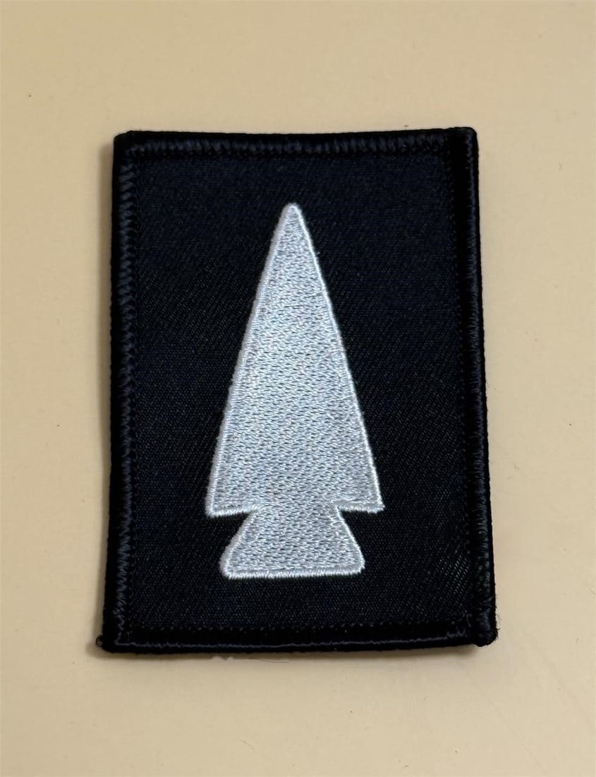 U.S. Army 364th Civil Affairs Brigade Patch: U.S. Army 364th Civil Affairs Brigade. This version is designed for use on the Army Combat Uniform (ACU). The patch features a white arrowhead on a black rectangular background. Purple and white are