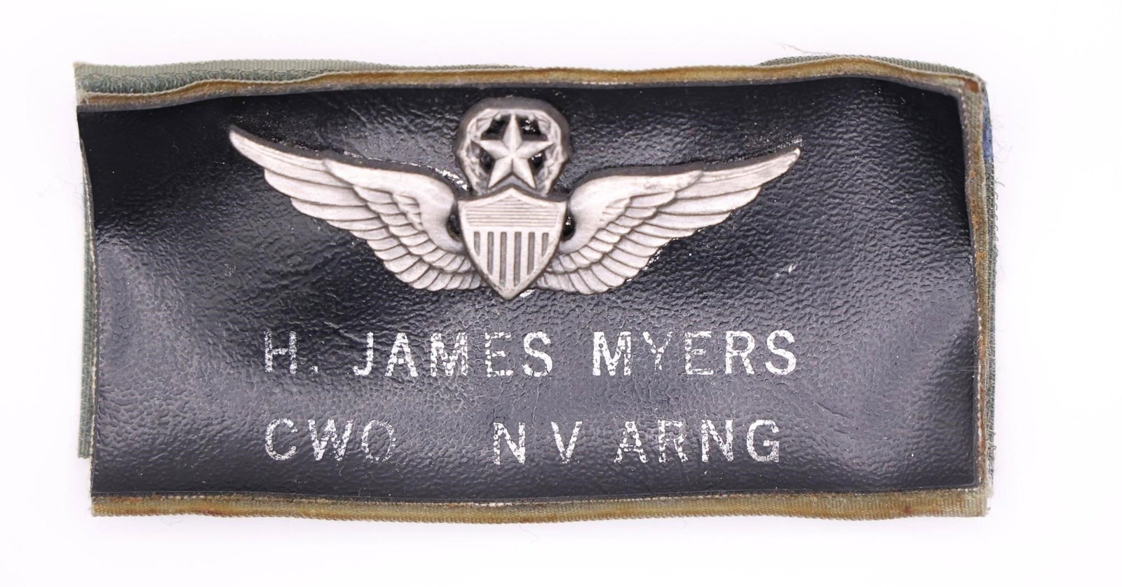 US Army Master Aviator Badge: The image shows a U.S. Army Master Aviator Badge mounted on a leather name tag for H. James Myers. The badge is awarded to soldiers who have demonstrated extensive proficiency and skill in aviation wi
