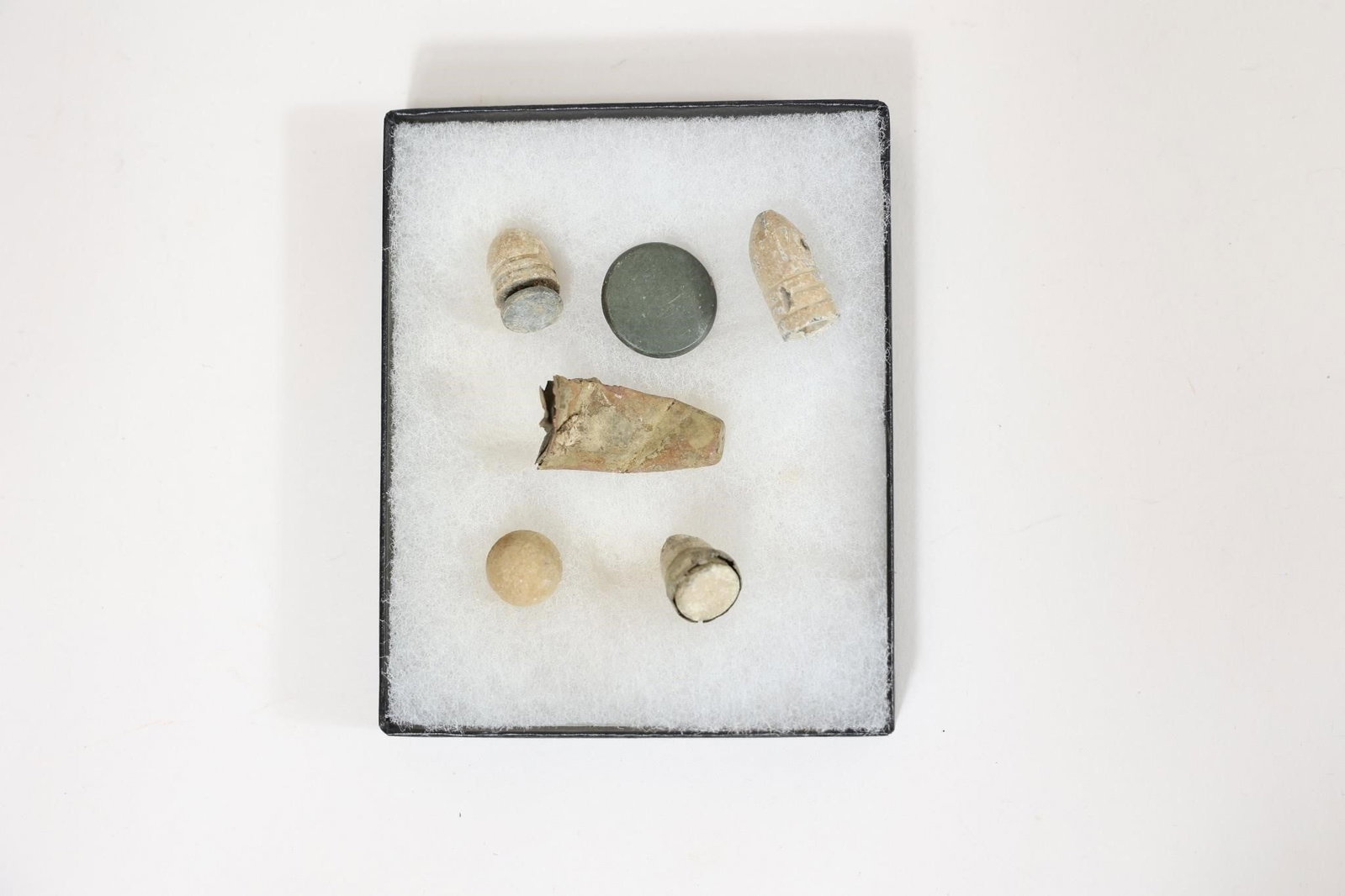 Civil War Relics: Group of Civil War era relics including bullets and fragments. Shows age, wear, and patina consistent with period use. Suitable for display or collection.