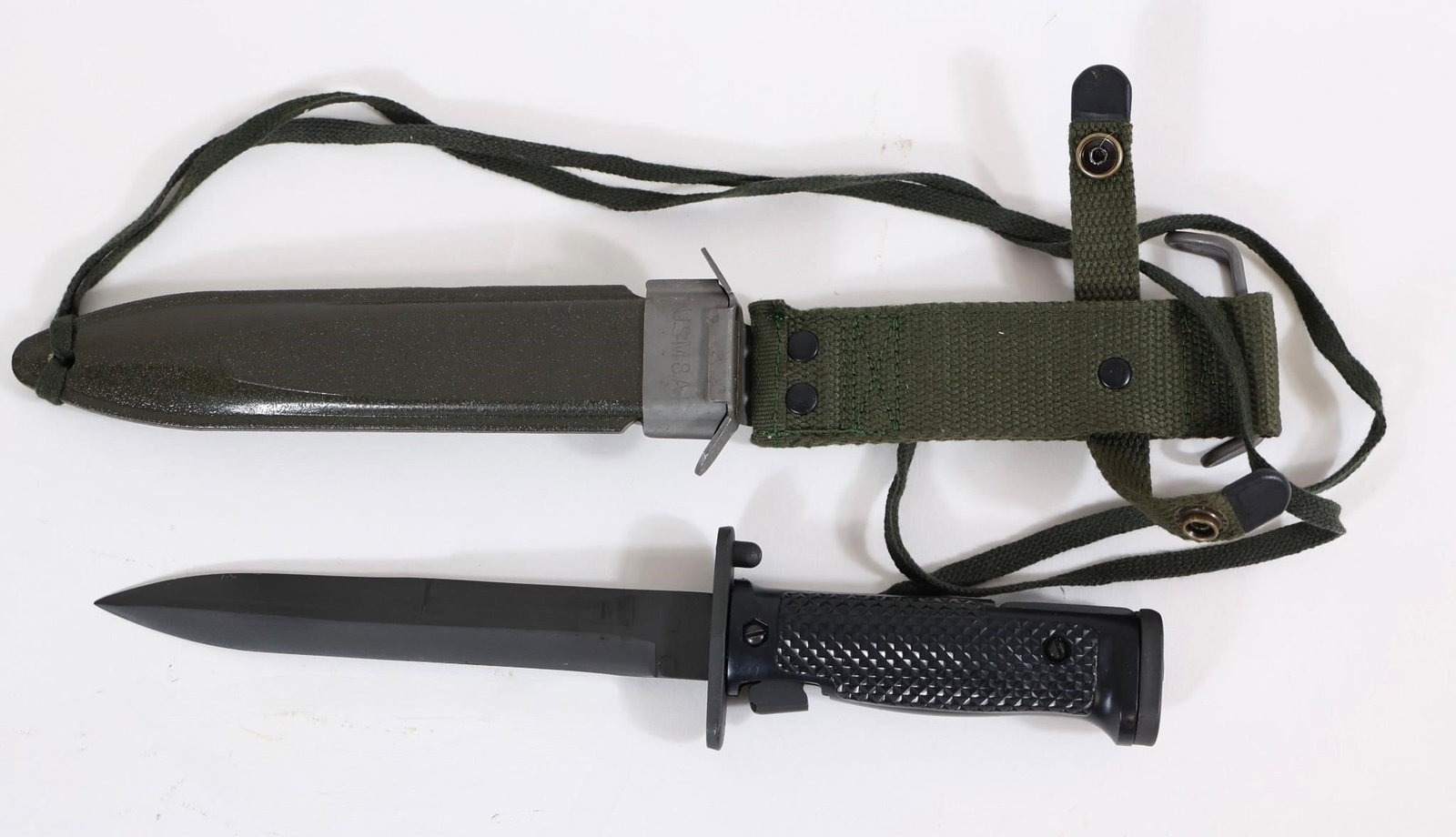US M5A1 Military Bayonet w/ Scabbard: US M5A1 bayonet with black handle and blade, includes green scabbard with strap. Shows light wear from use and storage.OL: 11.5"BL: 7"
