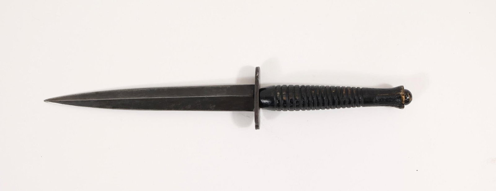 WWII THIRD PATTERN FAIBAIRN SYKES TROPICAL KNIFE: WWII era Third Pattern Fairbairn Sykes Tropical Fighting Knife. Double edged, blued blade. No visible marks. Blued steel 2" oval crossguard. Ribbed wood handle. Blade Length: 6 3/4" Total Length: 11