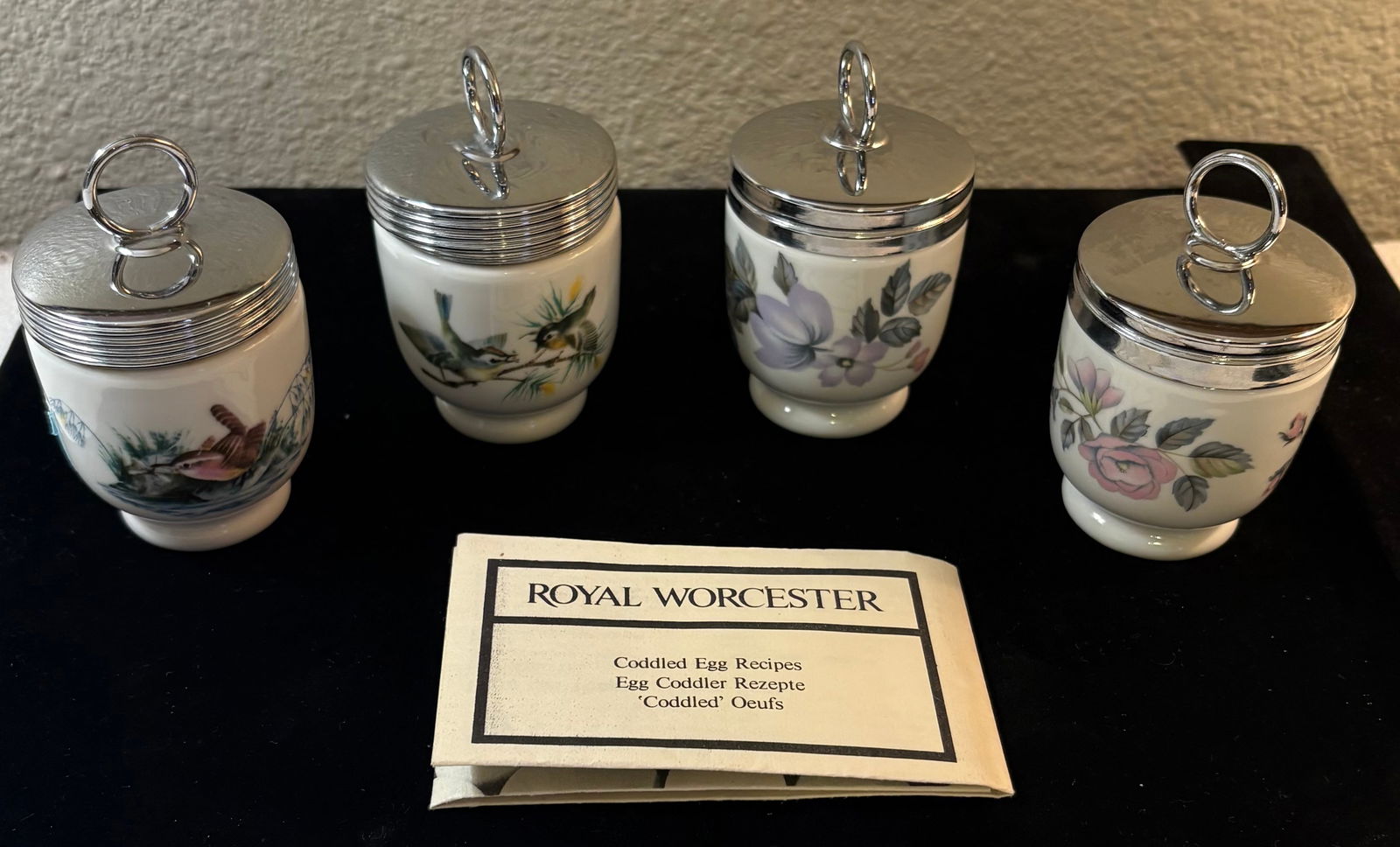 Vintage (1970s) British Royal Worcester Egg Coddlers x4: This lot features four Royal Worcester egg coddlers and an instruction & Recipe booklet. These porcelain cups are equipped w/metal screw top lids.There are two total designs, each printed on two