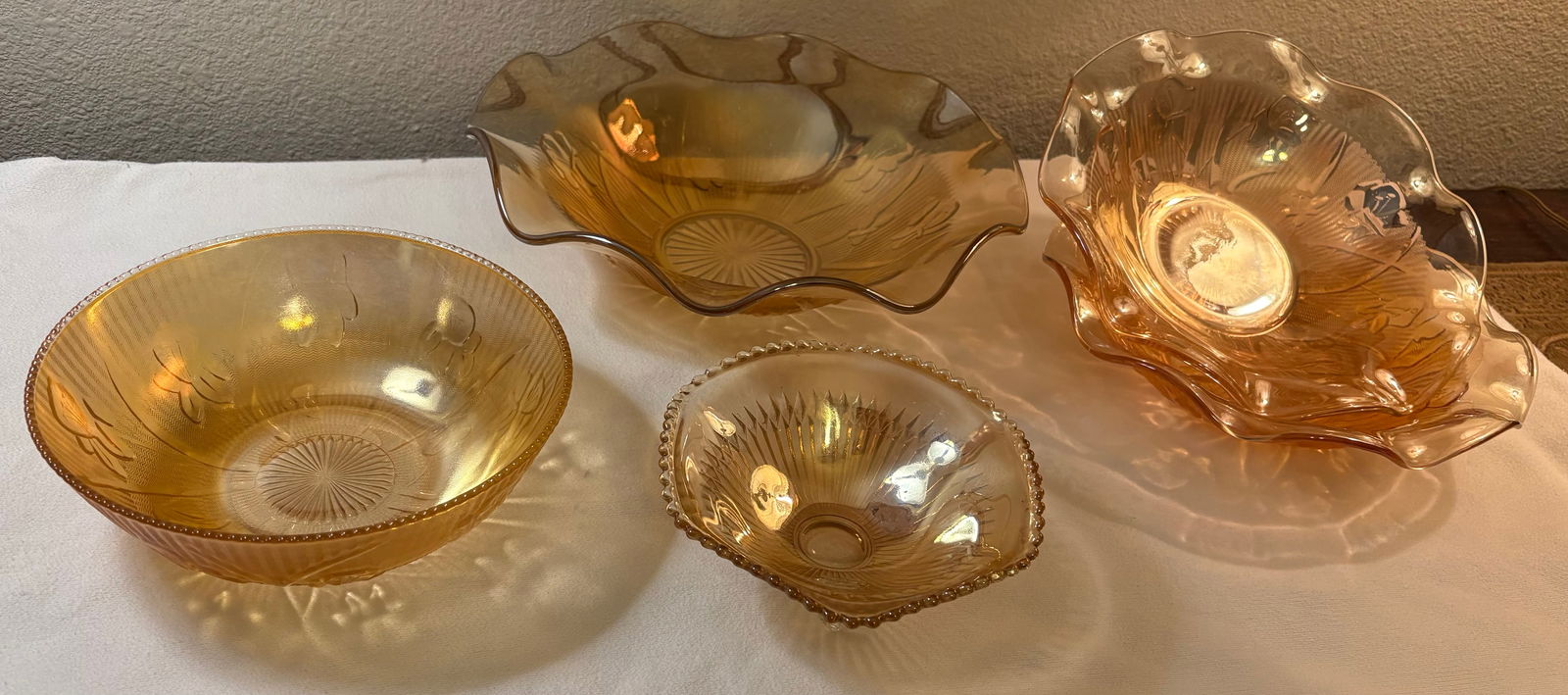 Vintage 5-Piece Iris & Herringbone Iridescent Marigold Carnival Glass Bowls: This lot features a 5-piece set of vintage depression glass era bowls.Jeannette "Iris & Herringbone" pattern carnival glass bowls in a marigold iridescent color.Manufacturer: Jeannette Glass Company,