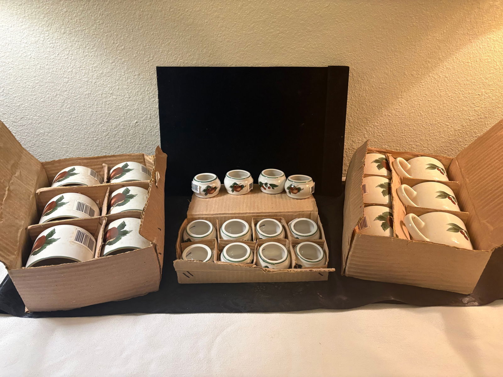 Vintage Cades Cove Napkin Rings and Coffee Mugs: This lot features a set of 12 Cades Cove Napkin rings and 12 Coffee Cups, all brand new in original packaging.Features:- High-quality porcelain & ceramic- White base w/vibrant cherry & apple patterns