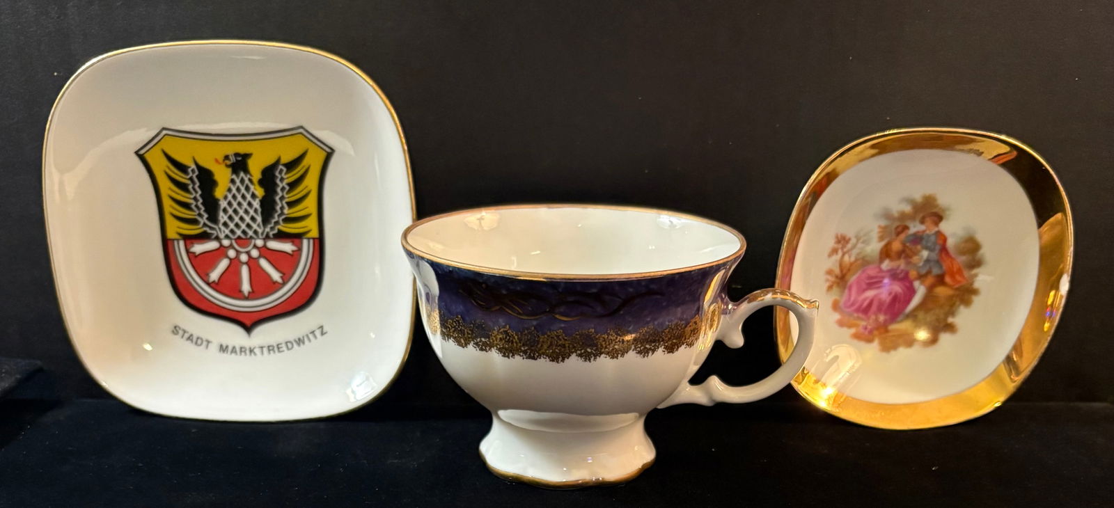Cold War Era Vintage German Porcelain Wares - Tea Cup, Coin/Ring Dish, & Coin/Trinket Dish: This lot features three vintage German porcelain wares, all with back stamps; a small size tea cup, a small size coin/ring dish, and a medium size coin/trinket dish.Item descriptions as follows:1.