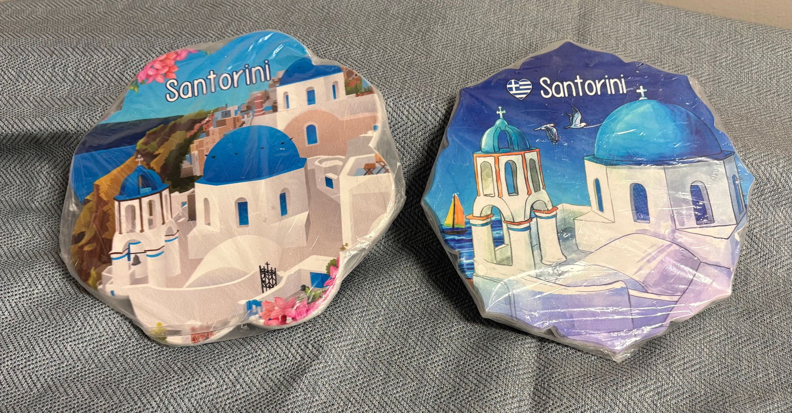 Pair of Greek Hand-Painted Ceramic Hot Plates - 2 Designs: This lot features a pair of Santorini Island (Greece) Souvenir “hot plates”. These are souvenir collectibles handmade in Greece depicting the beautiful Volcanic island of Santorini. Material -
