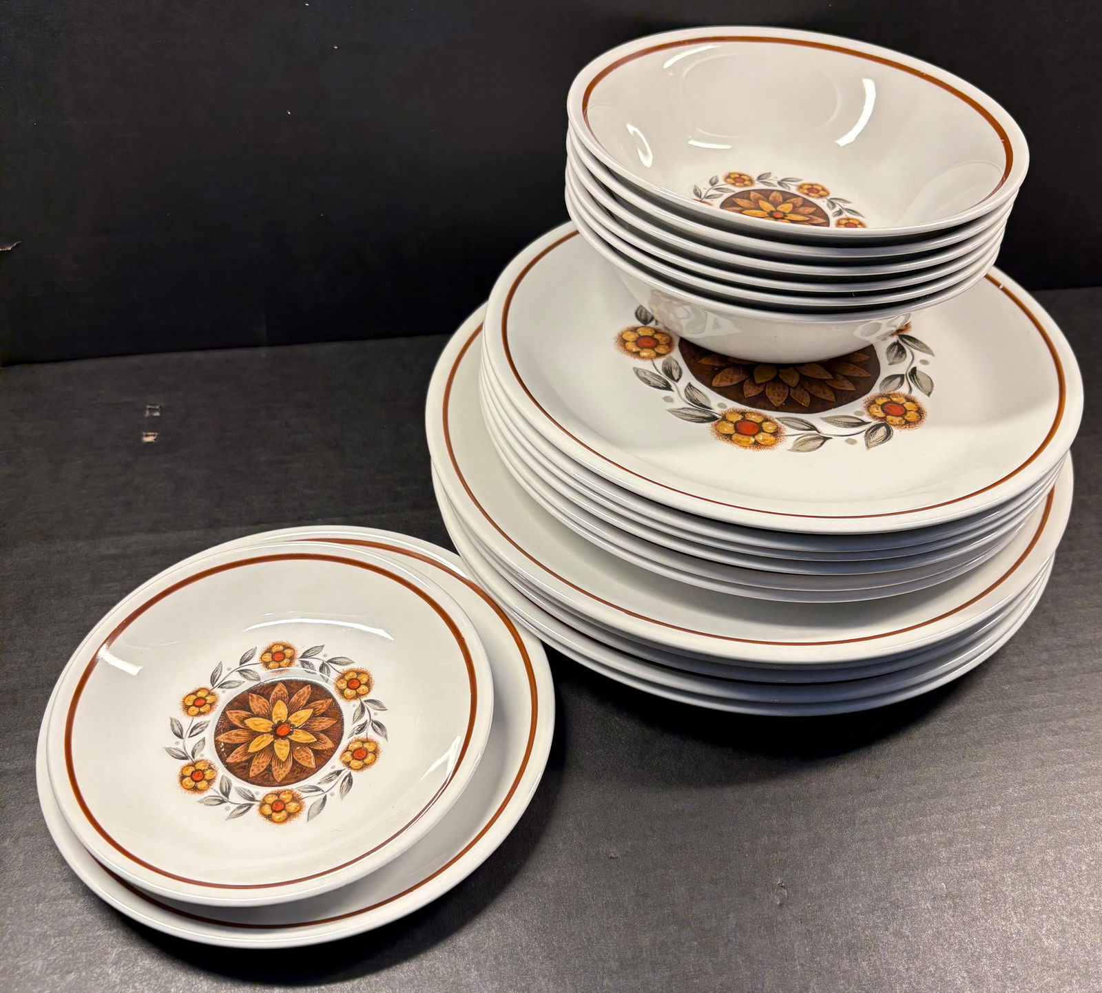 Vtg 19-Piece Alfred Meakin Glo-White Ironstone Fine Bone China - Tahiti Pattern: This lot features a 19-piece Alfred Meakin Glo-White Ironstone line in the Tahiti pattern. The pattern features a small central decal of an orange and yellow flower with green leaves. It's produced in