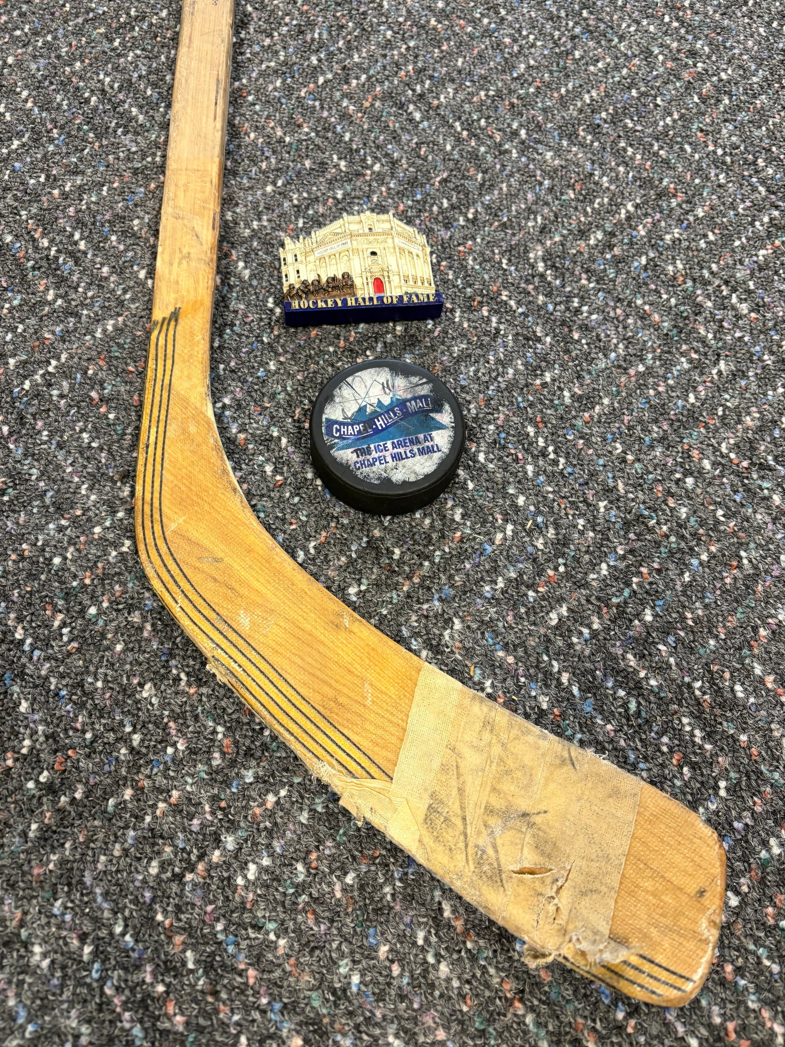 Vintage (1980s) CCM 552 Supra Hockey Stick + Game Used Hockey Puck & Hockey Hall of Fame Magnet: 1). CCM 552 Supra Hockey Stick (Vintage 1980s) - Part of CCM's "Supra" line, which was highly popular during the late 20th century. It's a classic wooden stick featuring a laminated wood shaft and a r