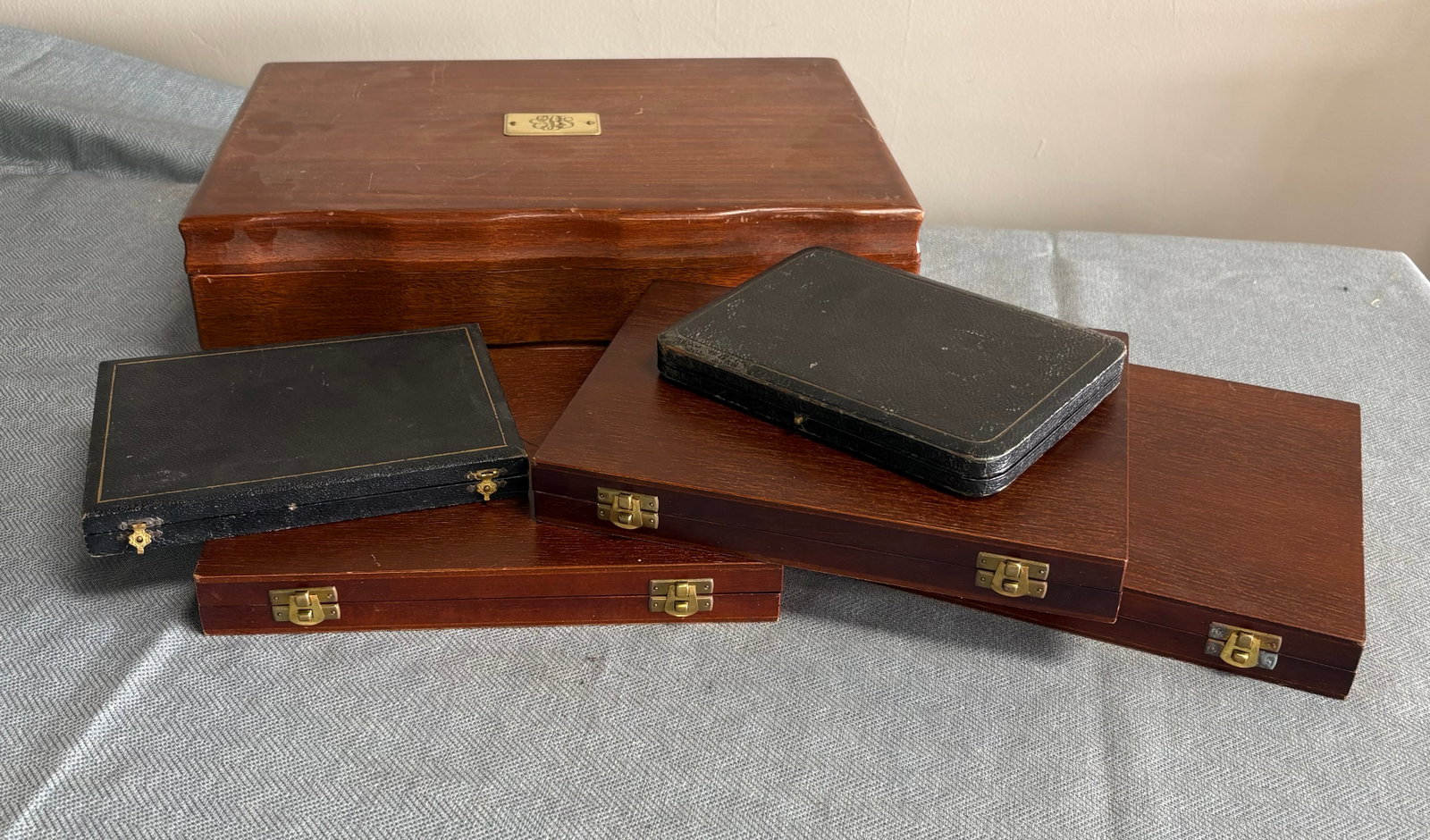 Vintage Collection of Six (British) Wooden Silverware/Flatware Storage Cases w/Hinges: This lot features a collection of 6 wooden silverware & flatware storage cases of varying sizes. All pieces are directly from England. They include...1). Large Storage Chest w/Distinctive Brass Namepl