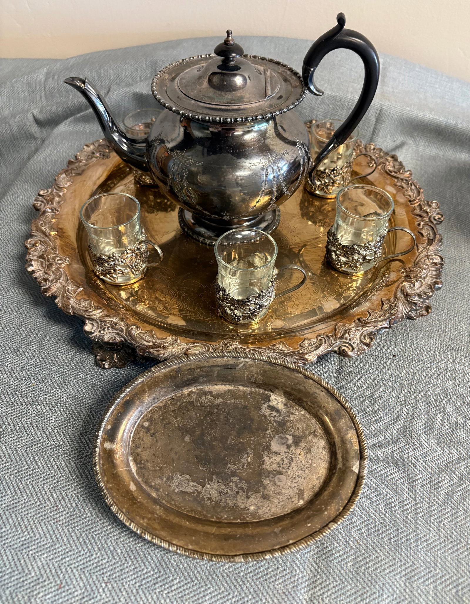 Vintage MCM 17-Piece Silver Plated Tea Pot & Serving Tray + Podstakannik Tea Serving Set: Victorian style silver-plated tea service set. The set includes...1). Vintage Silver Teapot: This ornate teapot features a decorative beaded rim, a hinged lid w/dark finial and black handle. It shares
