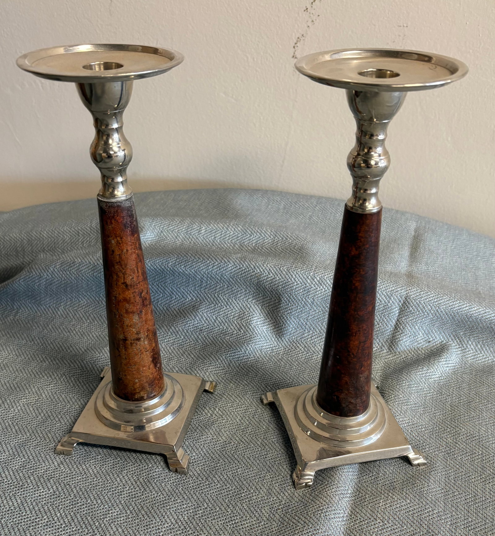 Vintage Pair of Indian Made Silver-Toned Candlesticks: Vintage silver-toned metal and wood candlesticks, made in India. They feature a classic Art Deco-inspired design with a tapered central wooden column set between a square silver-finished metal base an