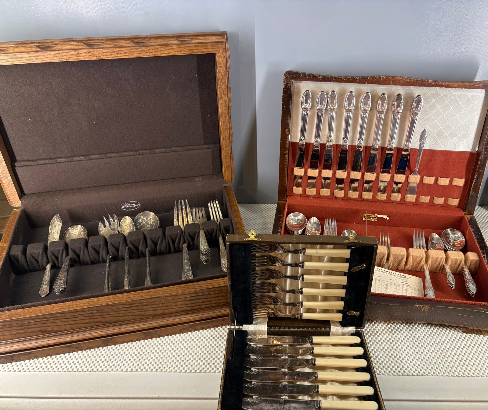 Antique/Vintage Trio of Cutlery Flatware w/Solid & Stable Storage Chests/Canteens: This lot features a trio of cutlery flatware from an assorted era all with nice, stable, and solid storage chests/canteens. They include...1). Antique 12-piece silver-plated fish cutlery set. It provi