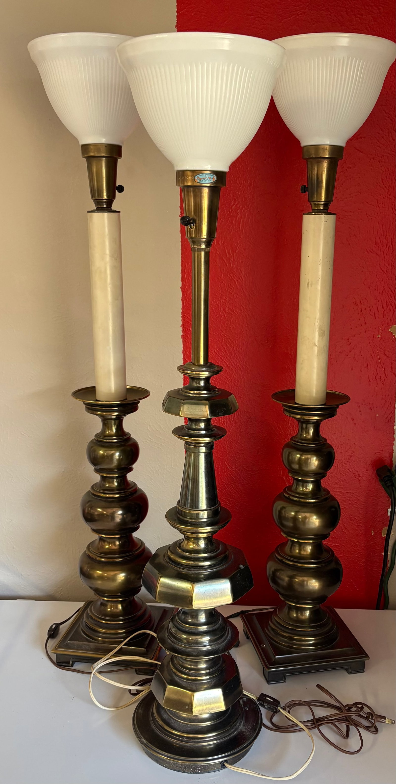 Vintage (MCM) Trio of Stiffel Heavy Brass Torchiere Table Lamps - Solid Brass Construction: Trio of vintage Stiffel heavy brass torchiere table lamps which are known for their high-quality materials and signature Mid-Century modern and Hollywood Regency designs. The central lamp explicitly d