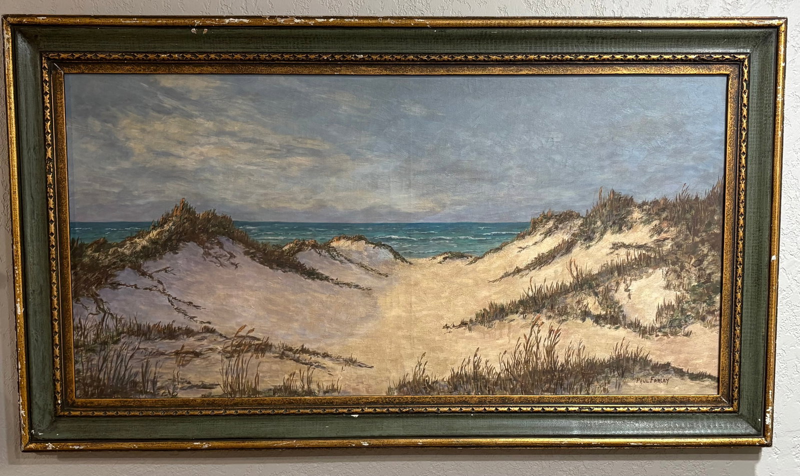 Vtg Paul Farley Coastal Landscape Framed Oil Painting - 46" x 32": This artwork is an original coastal oil landscape painting signed by Paul Farley, depicting a scenic view of coastal sand dunes leading out toward an open ocean under an overcast sky. A serene coastal