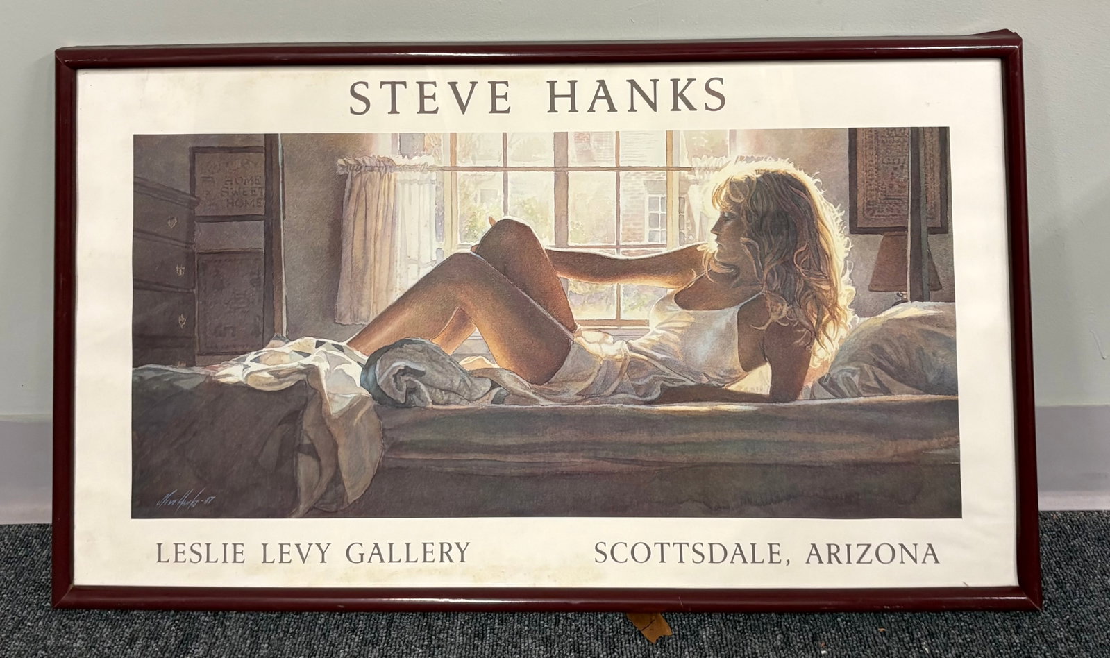 Vintage Framed Exhibition Poster Artwork titled, "Bedroom Light" - 33" x 19": A framed art print features the artwork "Bedroom Light" by acclaimed watercolorist Steve Hanks (originally created in 1987). "Bedroom Light" depicts a woman lounging in soft, natural light and is know
