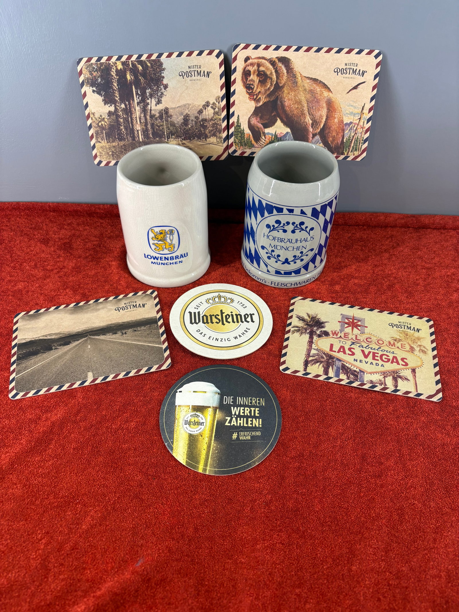 Vintage/Authentic (German) Traditional Beer Hall Barware Collection: Vintage collection of authentic German brewery barware alongside classic promotional pub coasters. Featured in this lot is....1). Löwenbräu München Stoneware Mug - This traditional mug displays the