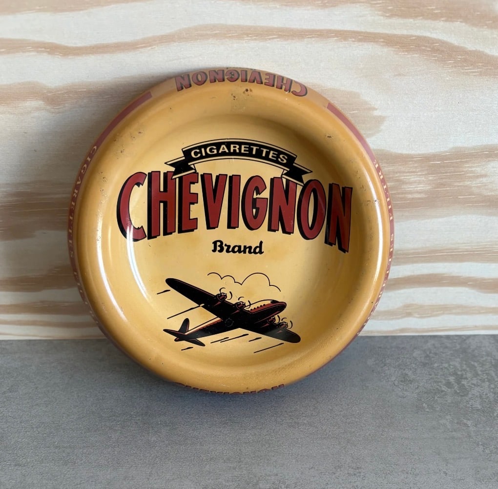 Vintage (1990s) French (Metal/Tin) Chevignon Cigarettes Ashtray: Authentic French vintage metal ashtray from the Chevignon brand with a retro aviation design. Chevignon is a French clothing company that produced these ashtrays to promote a brief venture in its own 
