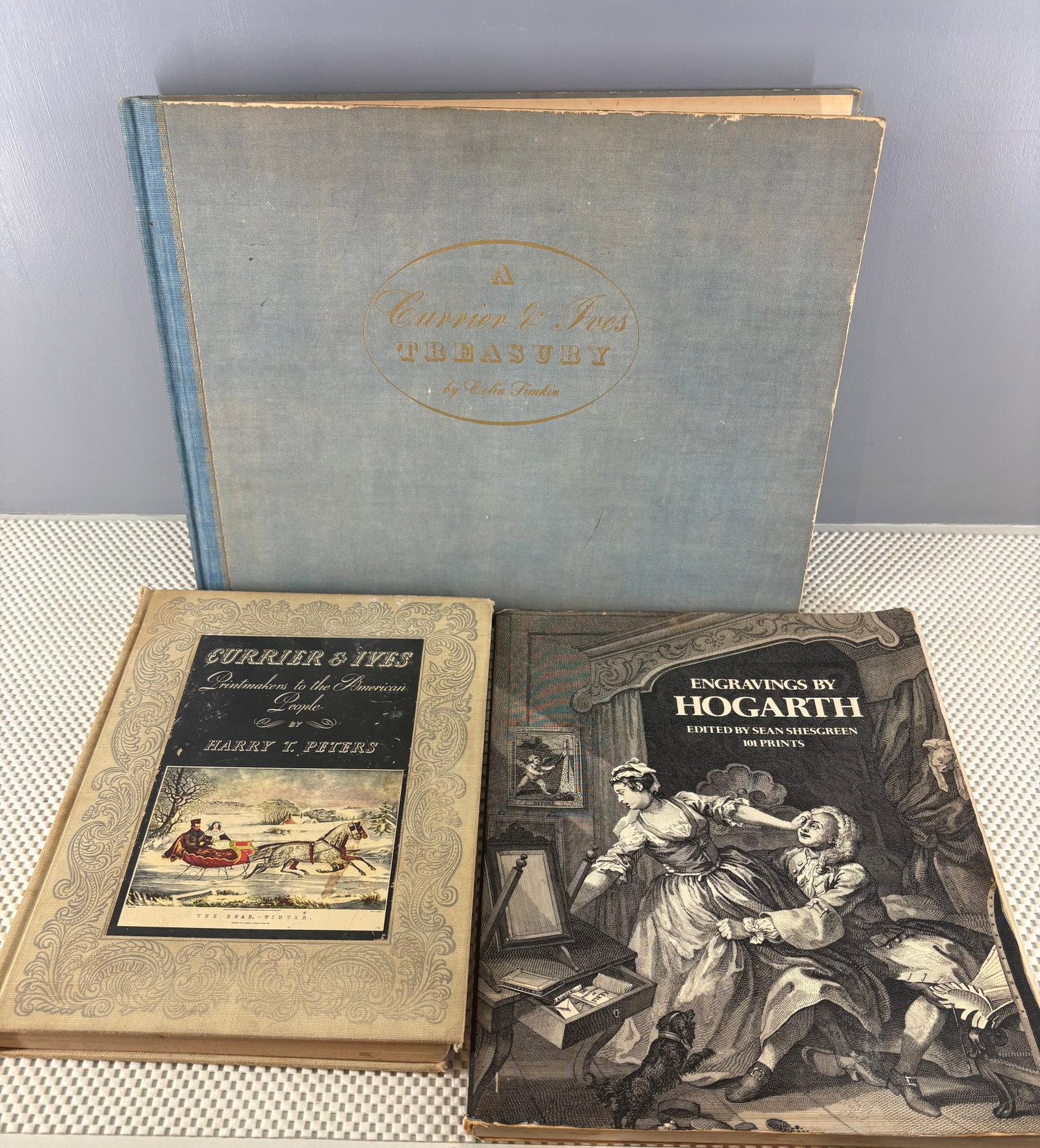 Vintage (1942-73) Currier & Ives and Hogarth Historical Art Grouping: Three vintage art book collections showcasing the historical works of famous printmakers and artists. The featured books are....1). A Currier & Ives Treasury - Edited by Colin Simkin and published in 