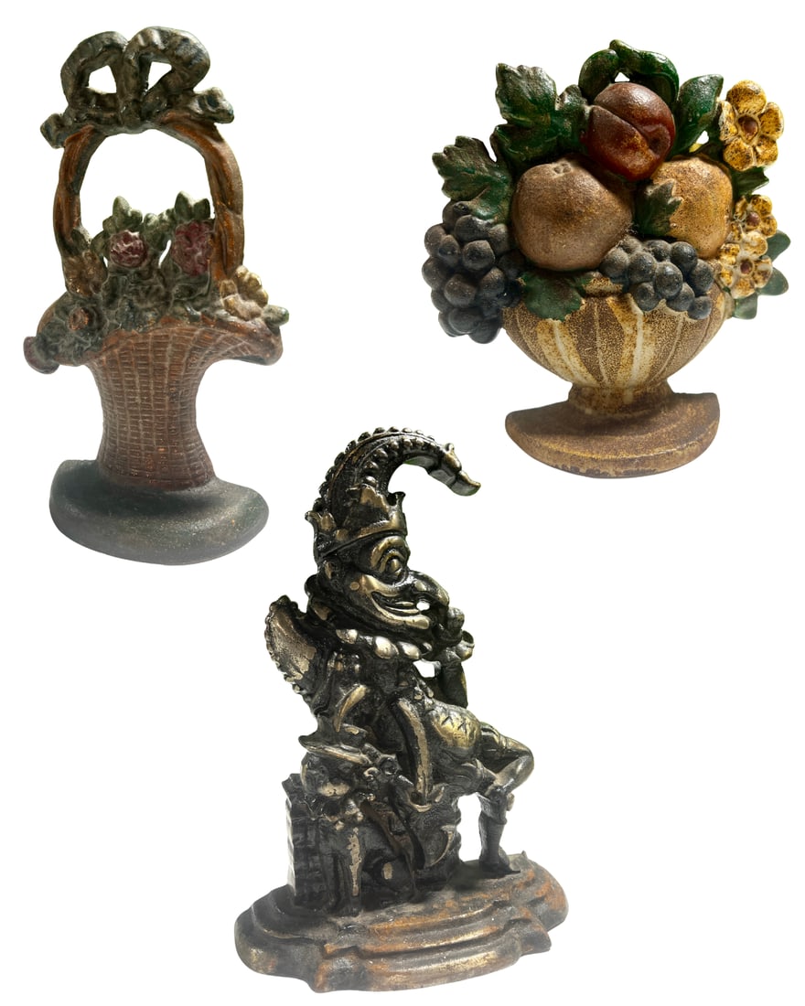 3 Vintage Cast Iron Doorstops: First: Hubley, "Basket of Flowers", original paint, H: 10 1/2", W: 7", D: 1 3/4", Second: John Wright, "Basket of Fruit", original paint, H: 6 1/4", W: 6 1/2", D: 1 1/2". Third: "Mr. Punch", H: 12", W