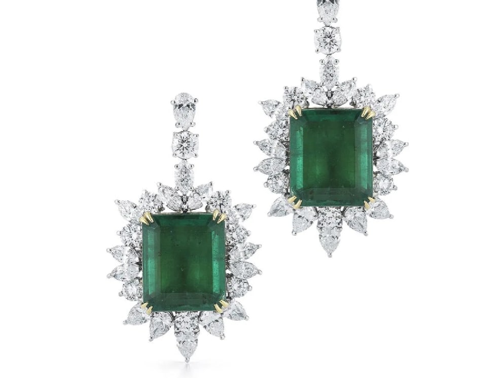 18K Gold 31.38ct. Emerald And Diamond Earring: Estimate $84,000-$92,400Luxurious emeralds are nestled within dramatic diamond halos. Item:# 01696 Setting:18K W Lab:GIA Color Weight:31.38 ct. of Emerald Diamond Weight:11.63 ct. of Diamonds