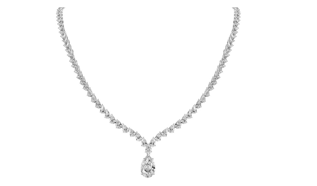 GIA Certified 33.00ct Pear Diamond Tennis Necklace: The Pear Diamond Tennis Necklace is a testament to extraordinary craftsmanship, designed for those who seek the pinnacle of luxury. Meticulously crafted in 18k white gold, this masterpiece showcases a