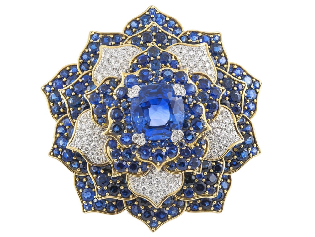 Vintage 1980s Verdura 20.01 Carat Sapphire Flower Brooch with Diamonds GIA certification: Vintage 1980s Verdura 20.01 Carat Sapphire Flower Brooch with DiamondsFinely crafted in 18k yellow gold and platinum with an AGL certified center Ceylon origin, non-heat treated Cushion cut Sapphire w