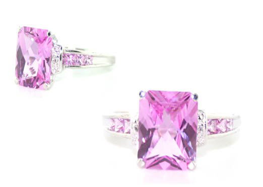 5 Cara Diamond Pink Topaz 10Kt Gold Ring: 10Kt white gold ring with a fancy princess cut pink topaz centered in the middle surrounded by small princess cut pink topaz stones mounted in the setting along with small round diamonds. Ring is a si