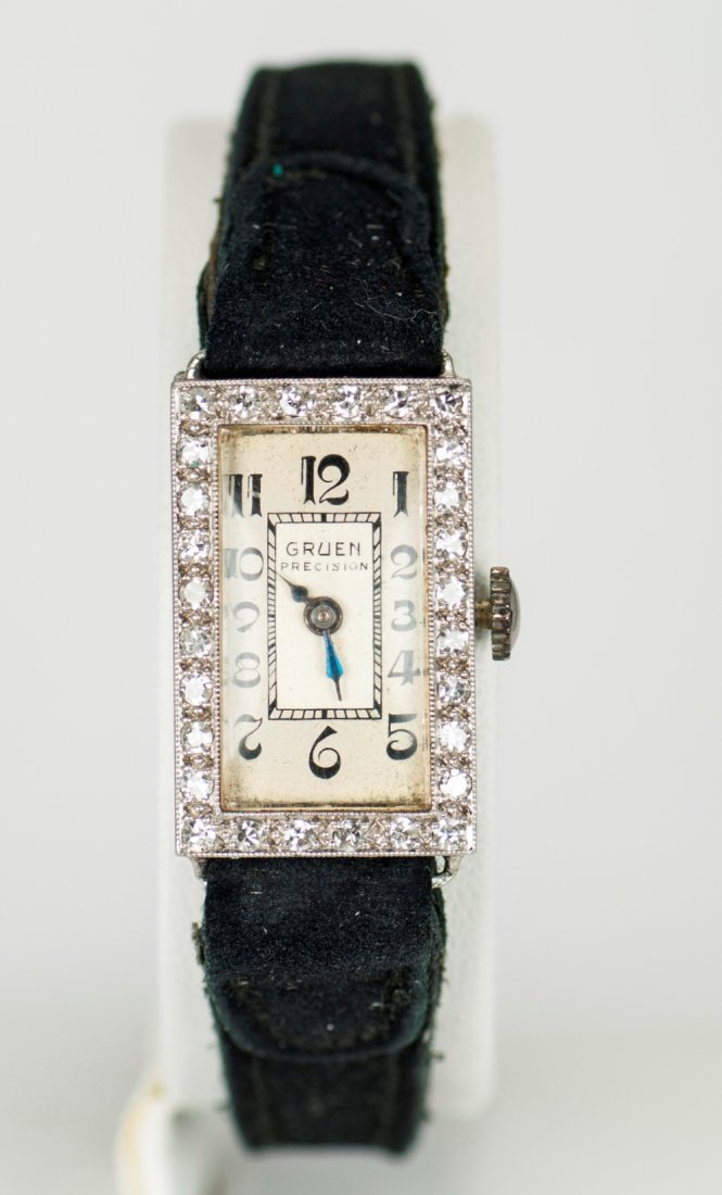 Art Deco Gruen Precision Watch with Diamonds: Art Deco style hand-wound watch with small rectangular face made of Platinum and Iridium, and surrounded by 17 jewels. Marked "Gruen." Total watch weight is 0.565 ozt. Case weight is approximately 0.2