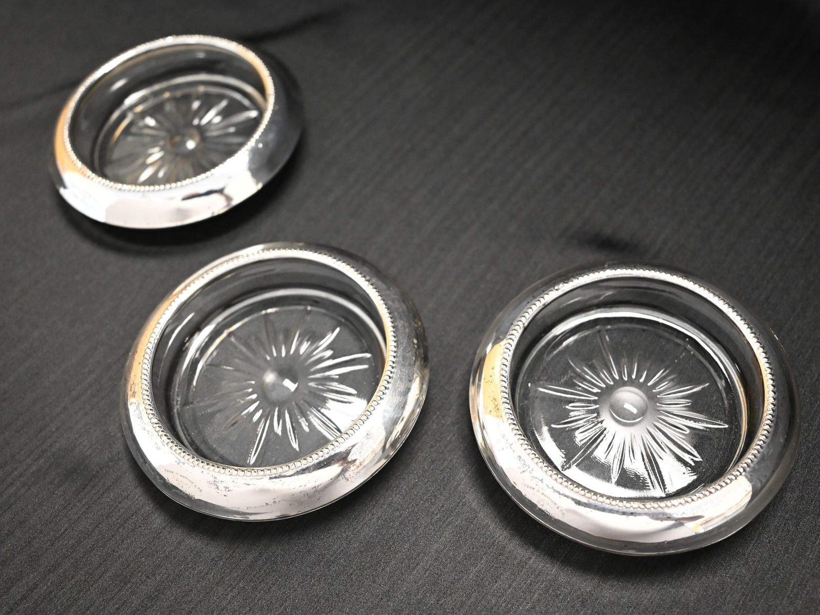 Three Frank M. Whiting & Co. Sterling Silver and Pressed Glass Coasters: A sophisticated set of three vintage sterling silver and glass coasters by the renowned American silversmith Frank M. Whiting & Co. of North Attleboro, Massachusetts (active under this