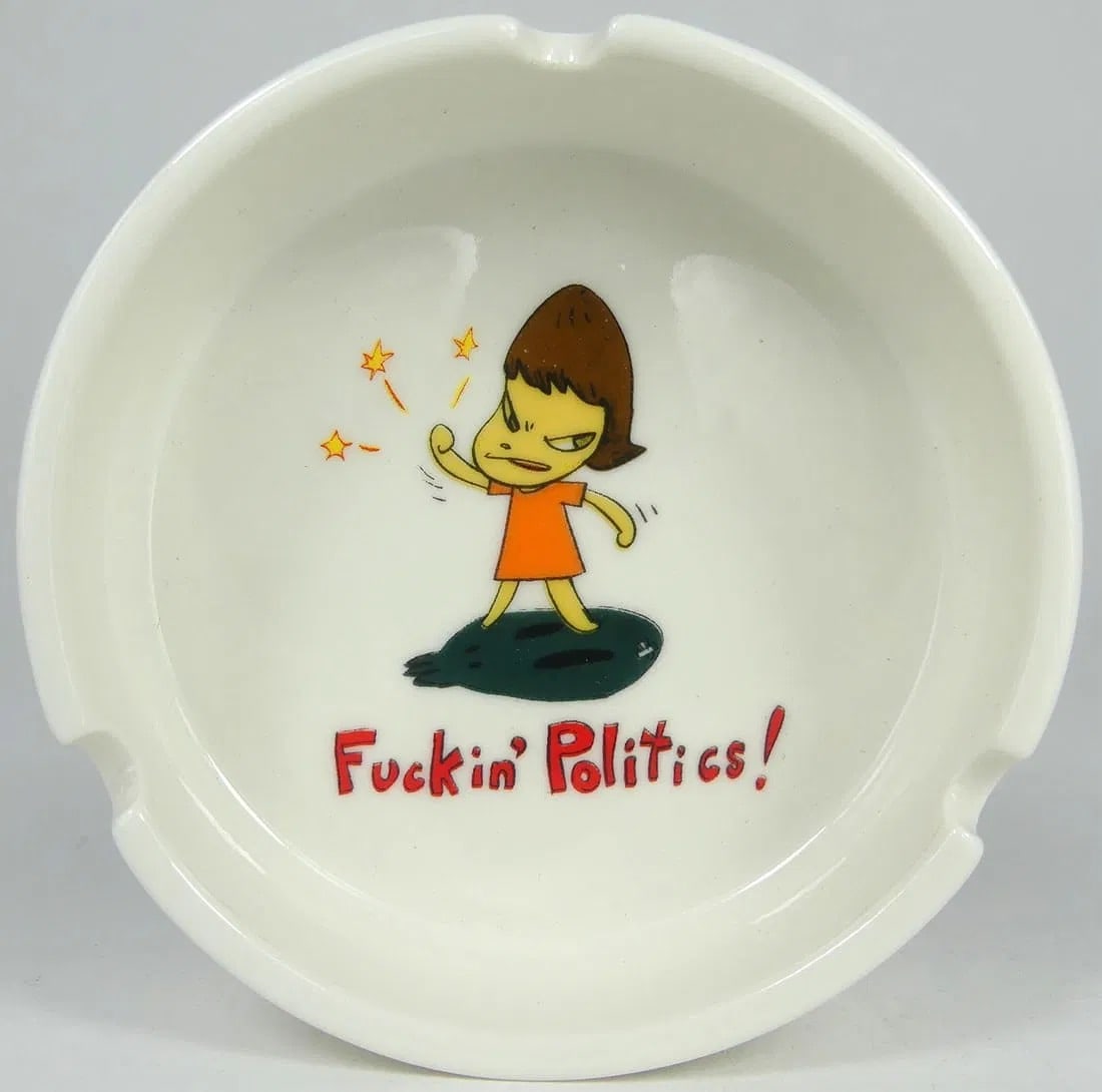 YOSHITOMO NARA 'F*CKIN POLITICS' CERAMIC ASHTRAY: Yoshitomo Nara 'Fuckin' Politics!' ceramic ashtray. Measures 4" x 4" x 1/4".
