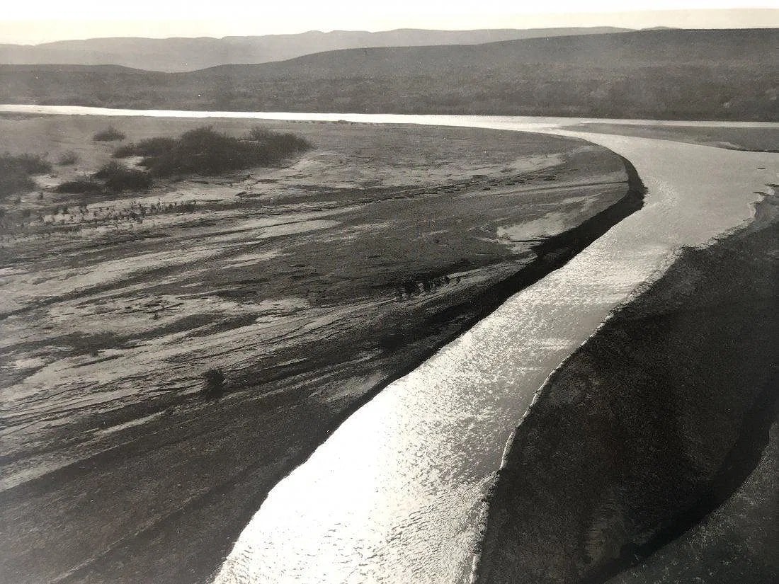 Ansel Adams - Big Bend National Park, Texas: ANSEL ADAMS (B.1902-1984) The Rio Grande, from Boquillas, Big Bend National Park, Texas Black and white photo on glossy paper 9.5" x 7.5"