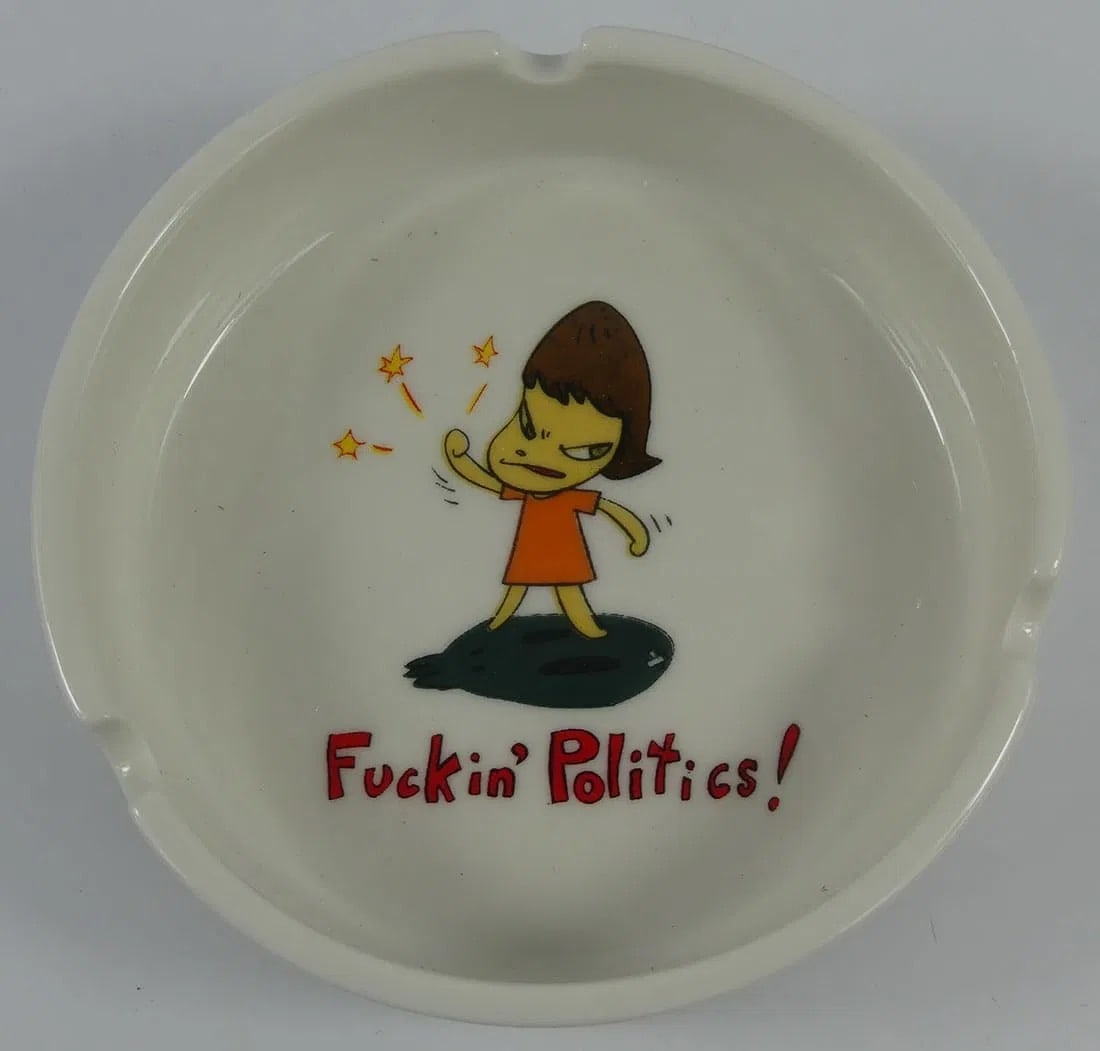 YOSHITOMO NARA 'FUCKIN POLITICS' CERAMIC ASHTRAY: Yoshitomo Nara 'Fuckin' Politics!' ceramic ashtray. Measures 4" x 4" x 1/4
