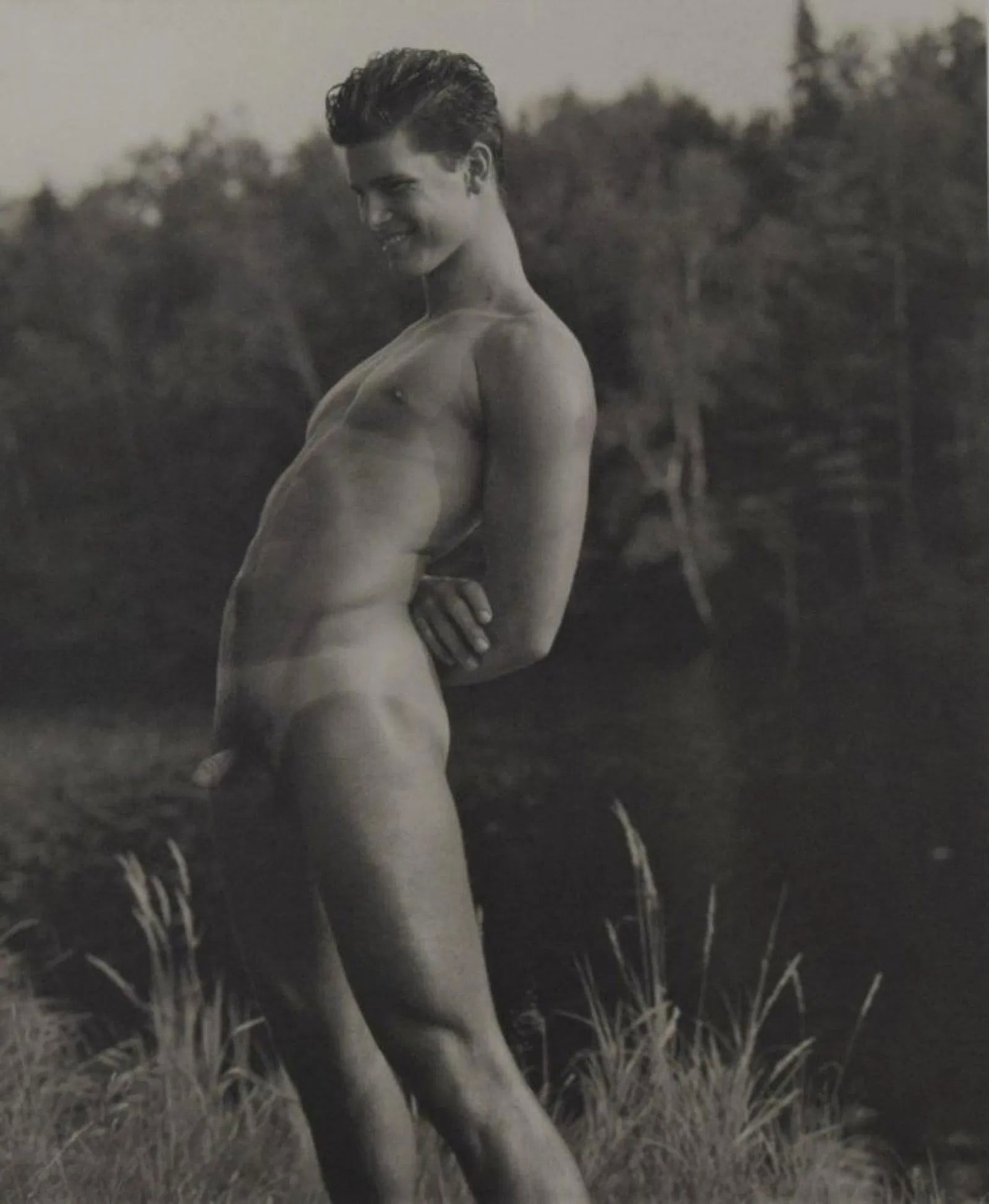 Bruce Weber - Rob at the Lean-to on the St. Regis River: BRUCE WEBER (b. 1946), Rob at the Lean-to on the St. Regis River, 1989, Sheet-fed gravure c. 1990, Printed in United States of America, 9 3/8" x 7 1/4", mounted to archival board