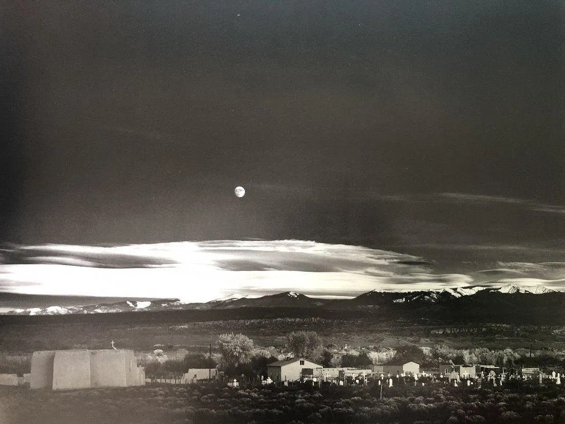 Ansel Adams - Moonrise, Hernandez, New Mexico 1944: ANSEL ADAMS (B.1902-1984), Moonrise, Hernandez, New Mexico 1944, Photo-litho, 11.5" x 15 1/4", Printed second half of 20th Century, Mounted to archival board